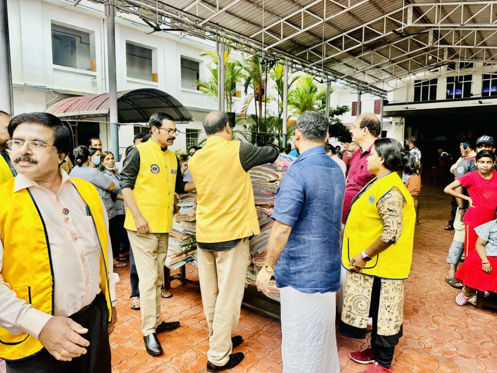 Image of The Lions Club Service distributing mats essential Goods to flood-affected residents in Thrissur, community support amidst the heavy rains and flooding, fostering community support and relief. under the guidance of Lion James Valappila PMJF, District 318D.Lions Club Project ,District 318d,Lions District 318d,
Lions Club India
Lions Club India,
Lions Club Kerala,
Lions Club Activities Project,Lions Childhood Cancer Project,
Lions Club Environment Project,
Lions Vision ProjectLion Club Kerala.Featured by www.jamesvalappila.com and authored by Lion James Valappila PMJF