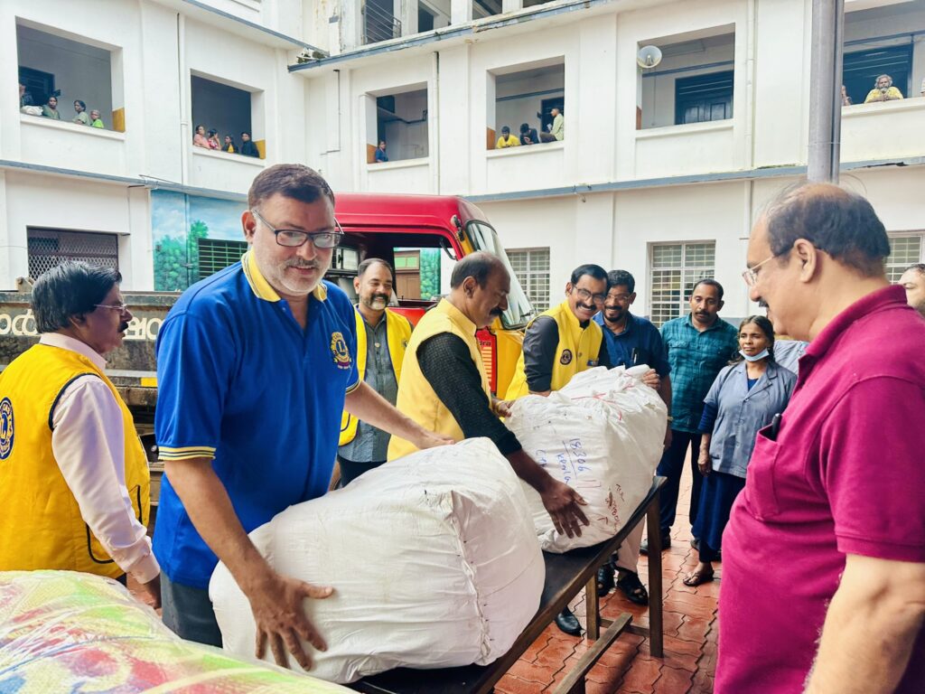 Image of The Lions Club Service distributing mats essential Goods to flood-affected residents in Thrissur, community support amidst the heavy rains and flooding, fostering community support and relief. under the guidance of Lion James Valappila PMJF, District 318D.Lions Club Project ,District 318d,Lions District 318d,
Lions Club India
Lions Club India,
Lions Club Kerala,
Lions Club Activities Project,Lions Childhood Cancer Project,
Lions Club Environment Project,
Lions Vision ProjectLion Club Kerala.Featured by www.jamesvalappila.com and authored by Lion James Valappila PMJF