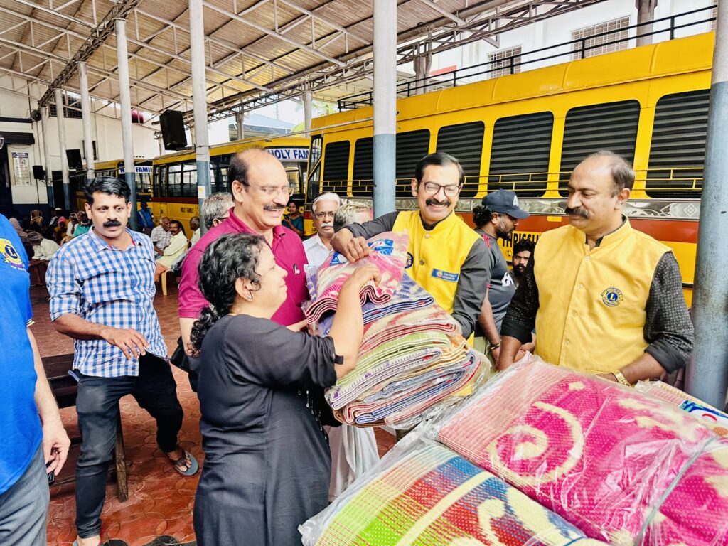 Image of The Lions Club Service distributing mats essential Goods to flood-affected residents in Thrissur, community support amidst the heavy rains and flooding, fostering community support and relief. under the guidance of Lion James Valappila PMJF, District 318D.Lions Club Project ,District 318d,Lions District 318d,
Lions Club India
Lions Club India,
Lions Club Kerala,
Lions Club Activities Project,Lions Childhood Cancer Project,
Lions Club Environment Project,
Lions Vision ProjectLion Club Kerala.Featured by www.jamesvalappila.com and authored by Lion James Valappila PMJF